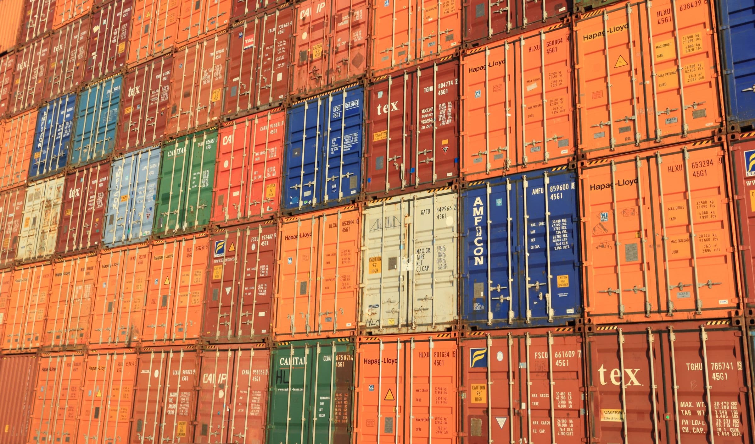 Stacked shipping containers ready for marine logistics and supply